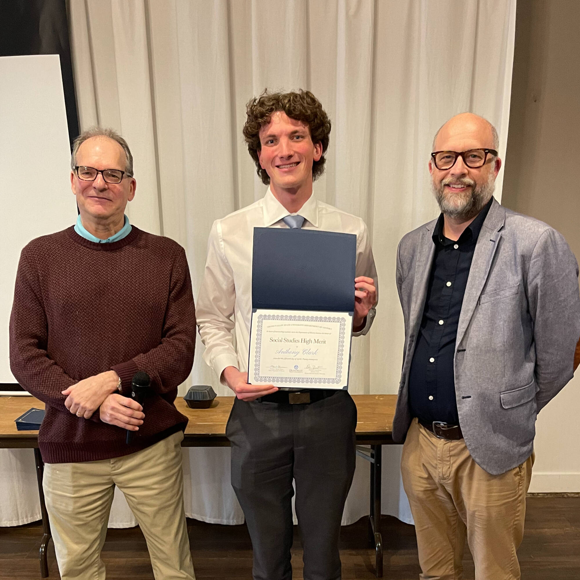 Anthony Clark holding award with professors Montagna & Huner